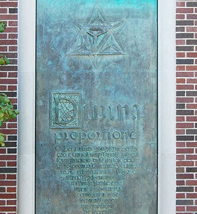 Bronze panel no. 1, based on the title page, Divina proportione, by Luca Pacioli, 1509, with one of Leonardo da Vinci's woodcut polyhedrons added at top; cast by Bruno Bearzi, 1965, north exterior annex wall, Linda Hall Library