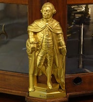 Statuette of James Bowdoin II, brass, possibly by Paul Revere, before 1787, one of four that adorn the base of the Joseph Pope orrery, Putnam Gallery, Harvard University (Wikimedia commons)