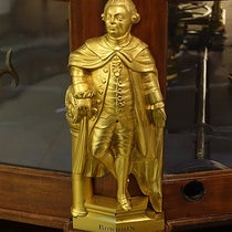 Statuette of James Bowdoin II, brass, possibly by Paul Revere, before 1787, one of four that adorn the base of the Joseph Pope orrery, Putnam Gallery, Harvard University (Wikimedia commons)