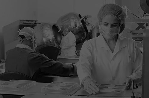 Employees in a clean room manufacturing sensitive materials.