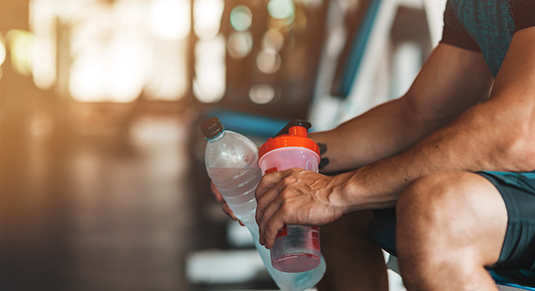 Man taking a water break from exercising