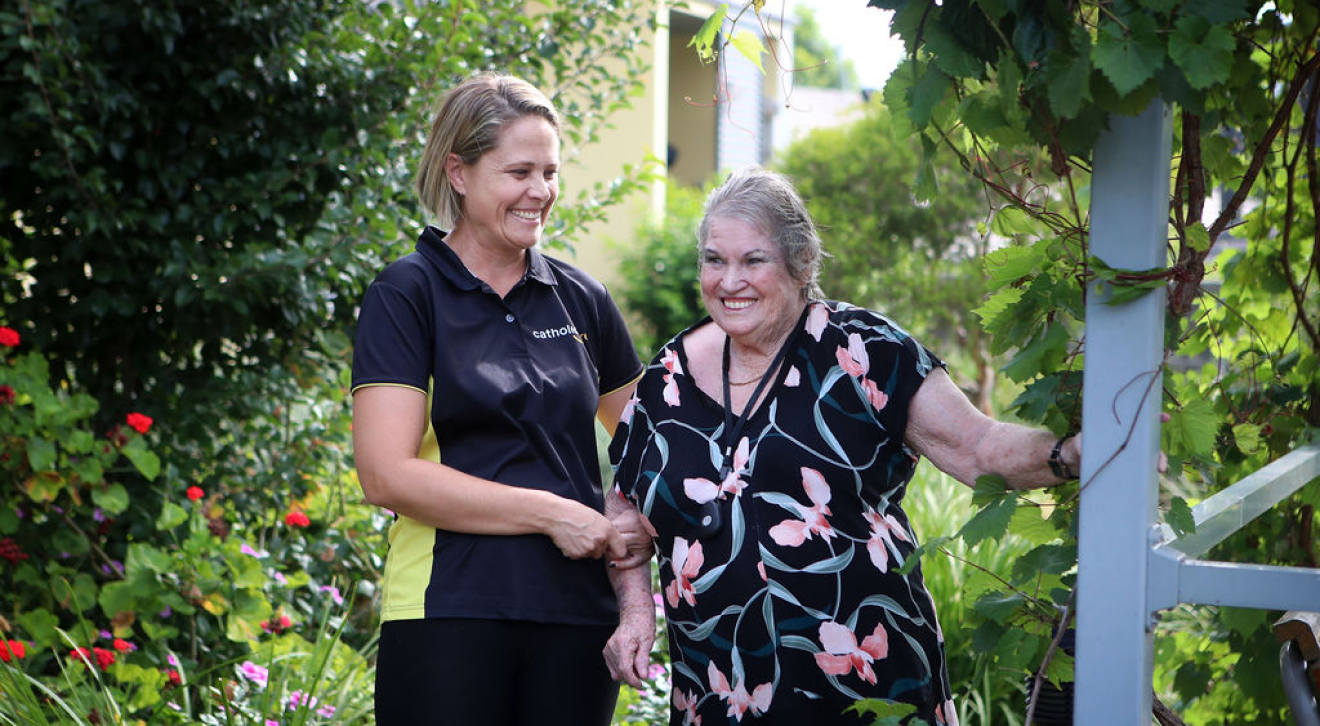 smiling woman being helped by CatholicCare