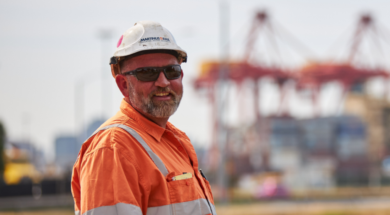 Smiling hi-viz man on wharf