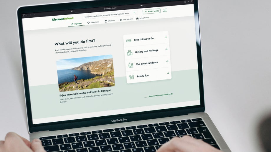 An individual is using viewing the different link options on the Discover Ireland homepage