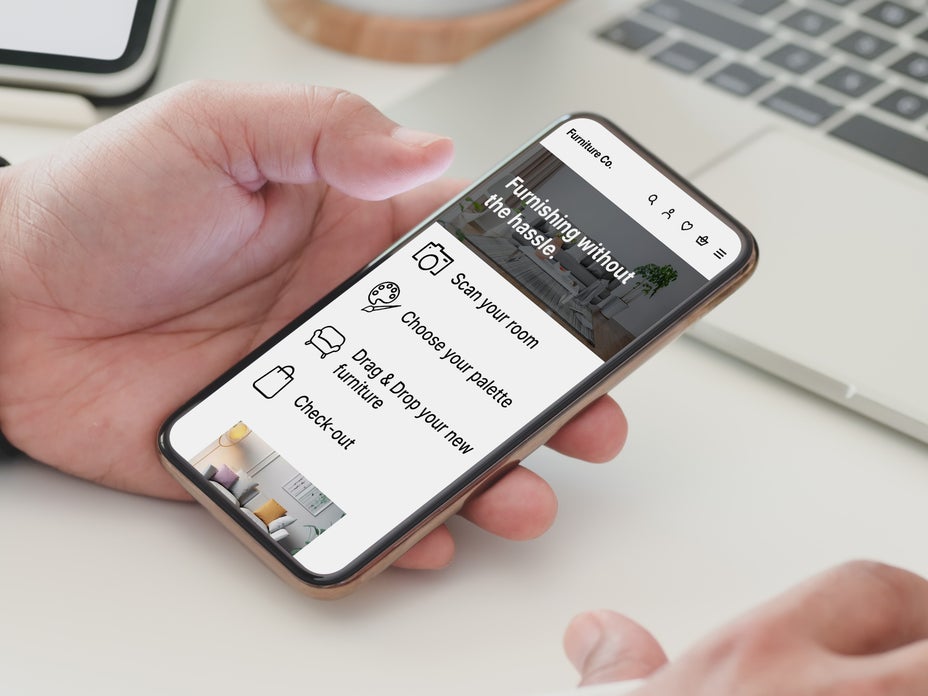 Person holding a phone on an AI furniture site