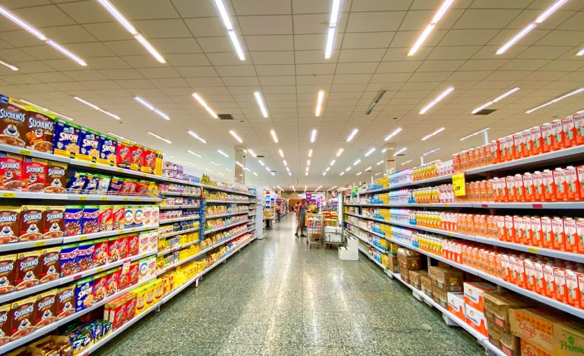 Supermarket aisle showing neatly stacked cereal boxes 