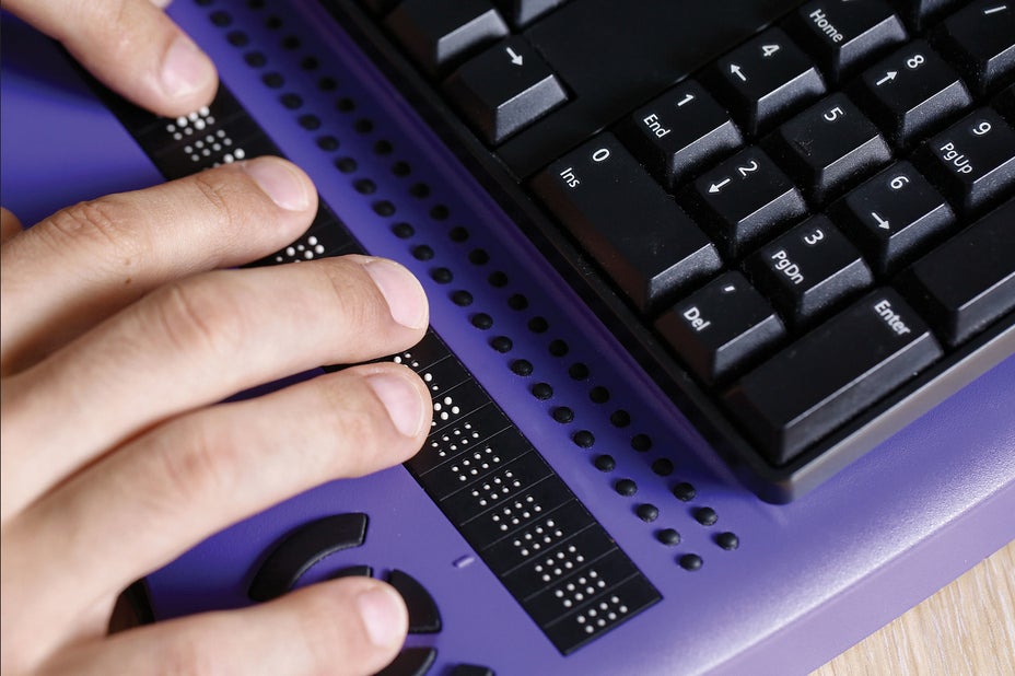 Person using a braille keyboard