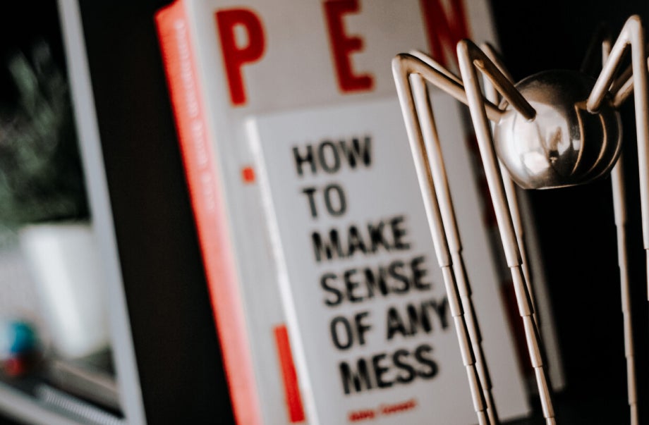 The Spider Award is placed on a shelf with design books behind it.