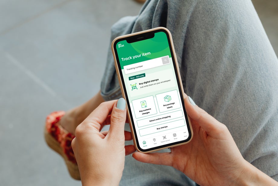 Digital Stamp app appears on the screen of a phone someone is holding