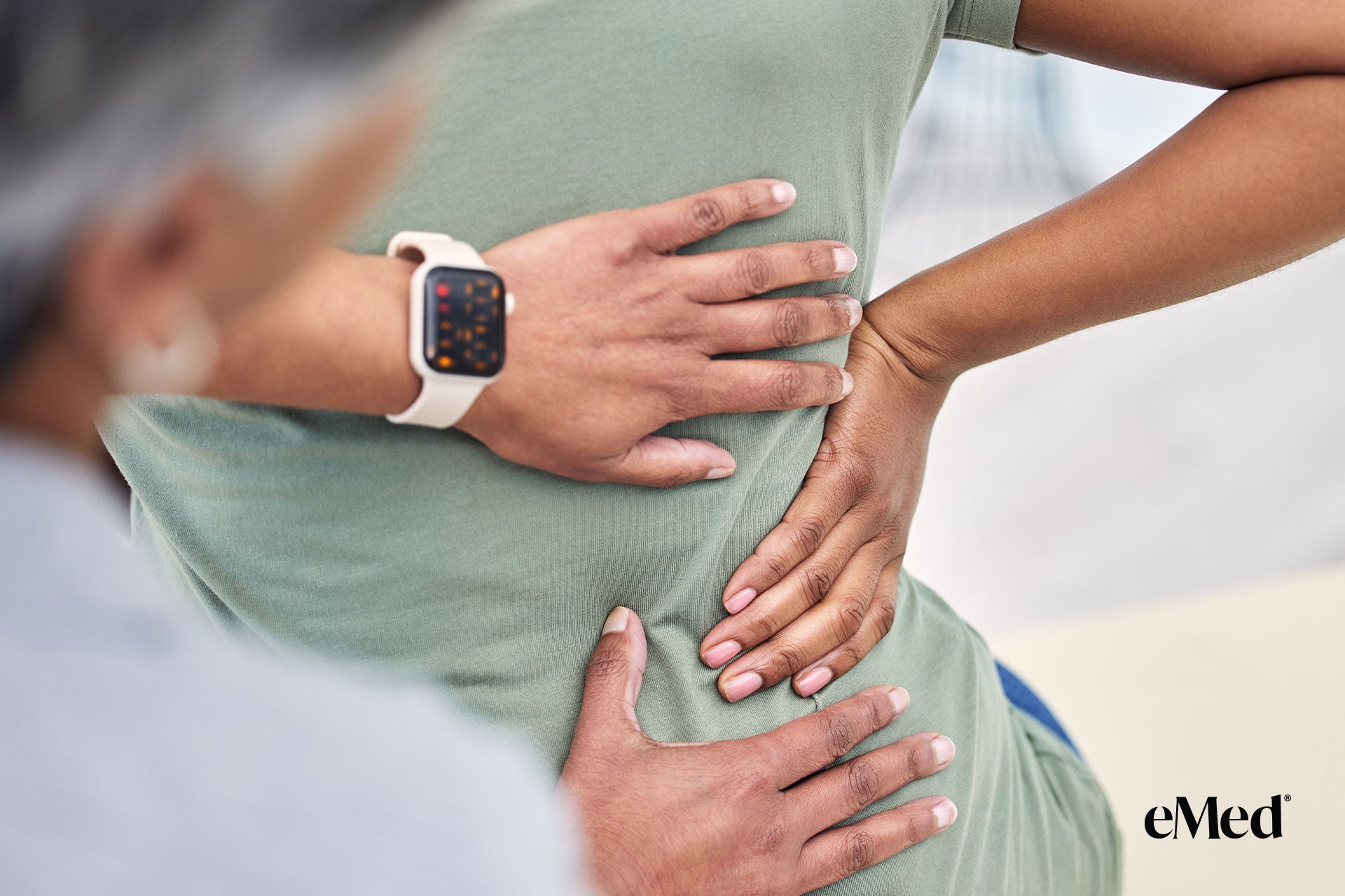 A physiotherapist guiding a patient through hip exercises