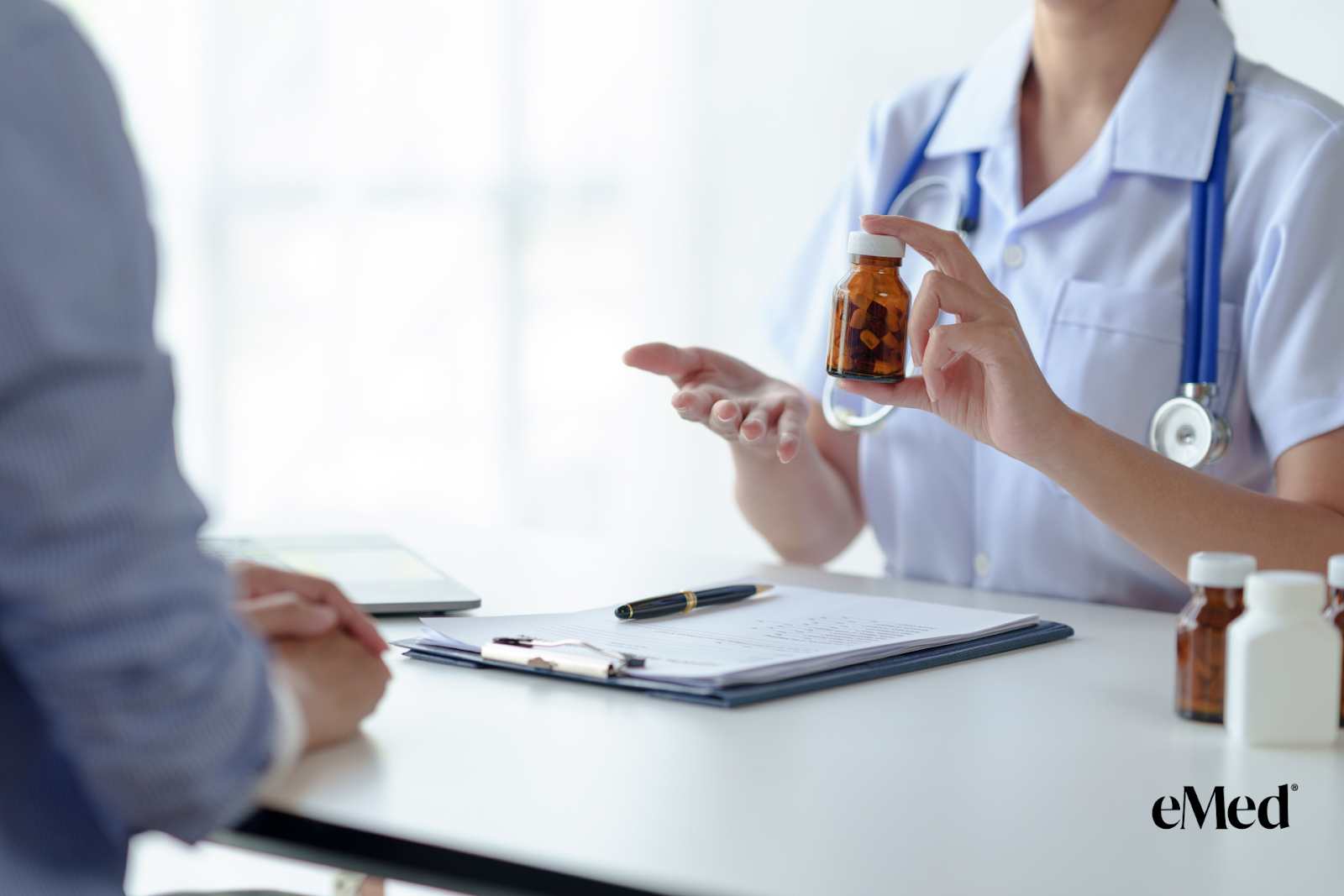 A doctor explaining medication to a patient during a consultation.