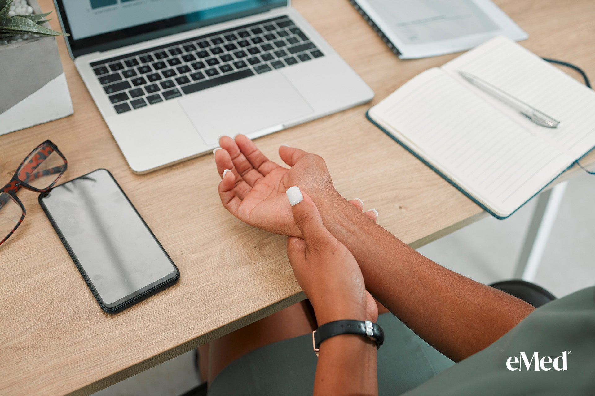 Ergonomically optimized desk setup to prevent carpal tunnel strain and person doing exercise 